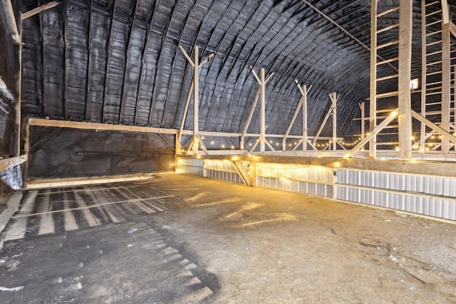 misc room featuring vaulted ceiling and brick ceiling