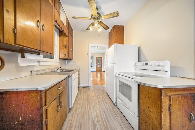 kitchen with ceiling fan, sink, white appliances, and light hardwood / wood-style flooring