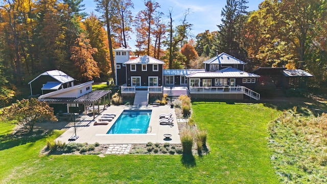 back of house with a patio, a lawn, stairway, an outdoor pool, and a wooden deck