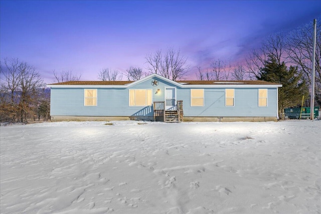 view of snow covered rear of property