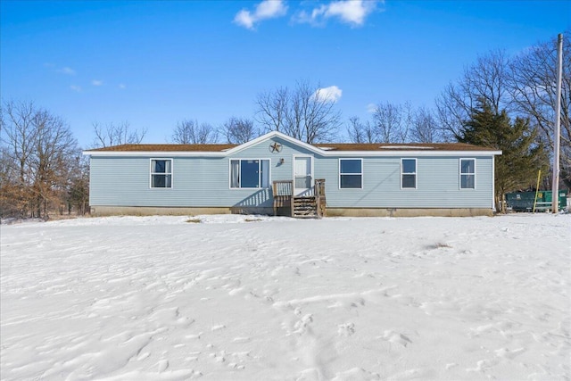 view of snow covered rear of property