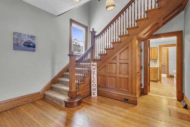 staircase with hardwood / wood-style flooring