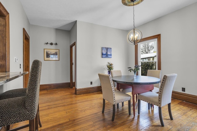 dining room with wood-type flooring and a chandelier