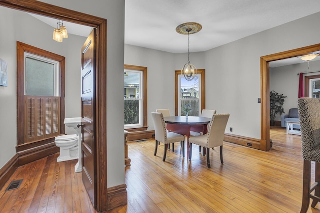 dining space featuring a chandelier and light wood-type flooring