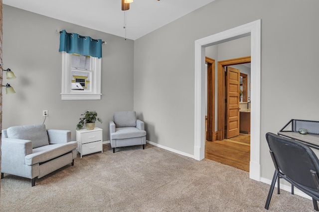 living area with ceiling fan and carpet flooring