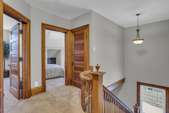 hall with light colored carpet