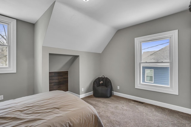 carpeted bedroom featuring vaulted ceiling