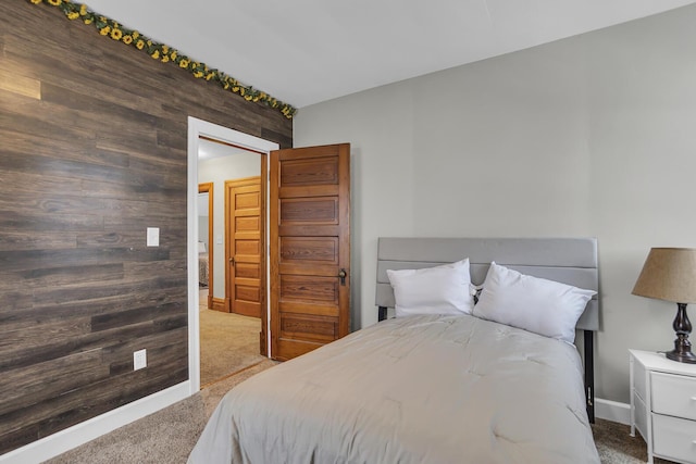 bedroom featuring carpet flooring and wood walls