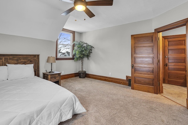 carpeted bedroom with vaulted ceiling and ceiling fan