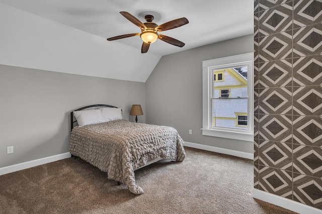 carpeted bedroom featuring lofted ceiling and ceiling fan