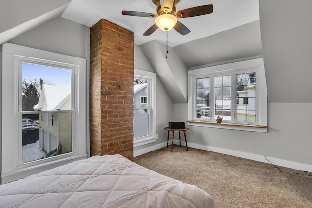 carpeted bedroom featuring ceiling fan, vaulted ceiling, and multiple windows