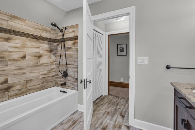 bathroom featuring vanity and tiled shower / bath combo