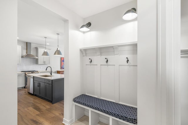 mudroom with sink and light wood-type flooring