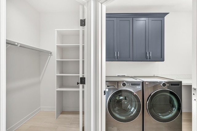 laundry area featuring cabinets and separate washer and dryer