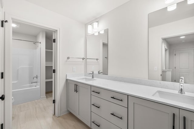 bathroom featuring washtub / shower combination and vanity