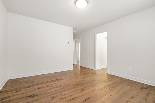 empty room with light hardwood / wood-style flooring