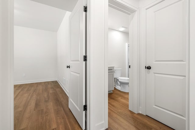 hallway with hardwood / wood-style flooring