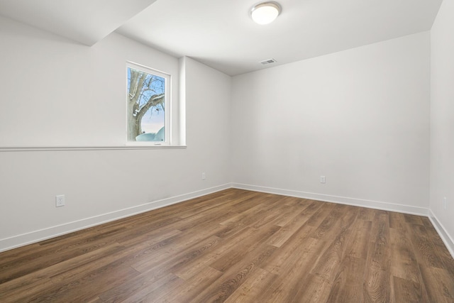 spare room with hardwood / wood-style flooring