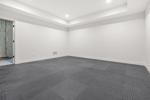 unfurnished room featuring a tray ceiling