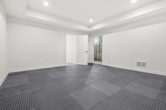 unfurnished room with a tray ceiling