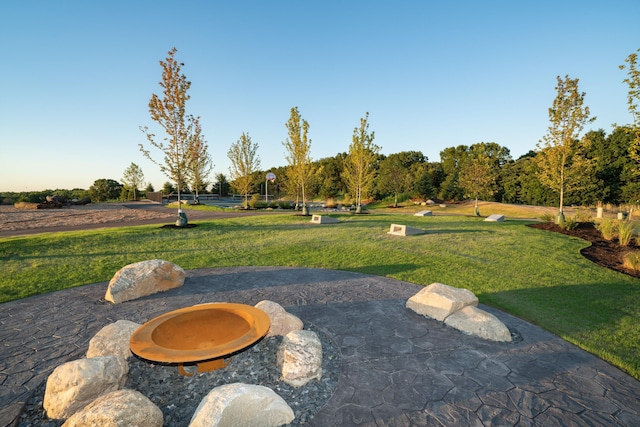 view of home's community featuring a lawn and a patio area