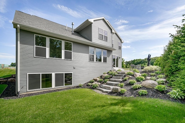 rear view of property with a lawn