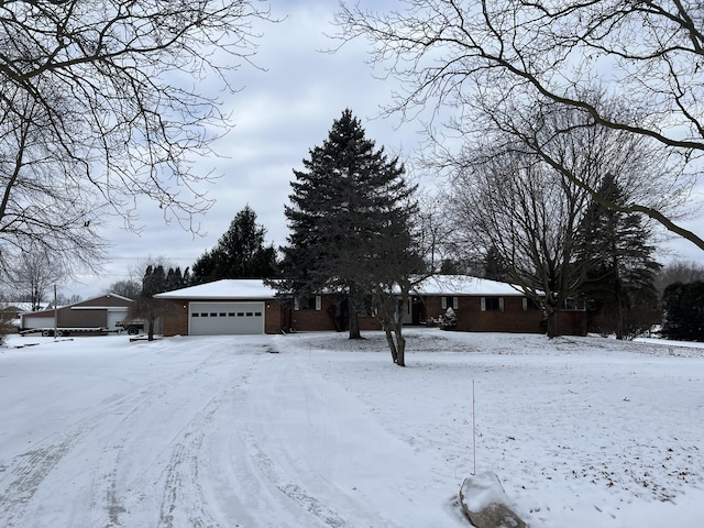 yard covered in snow featuring a garage