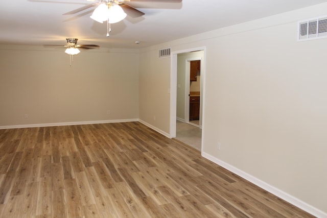 unfurnished room with ceiling fan and hardwood / wood-style floors