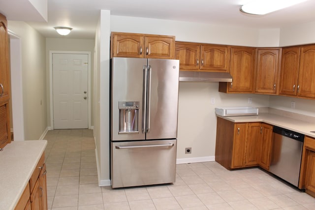 kitchen featuring light tile patterned floors and stainless steel appliances