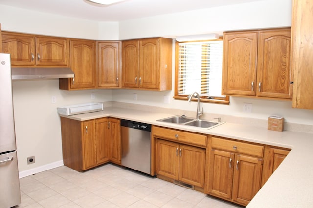 kitchen featuring stainless steel dishwasher, sink, and white fridge