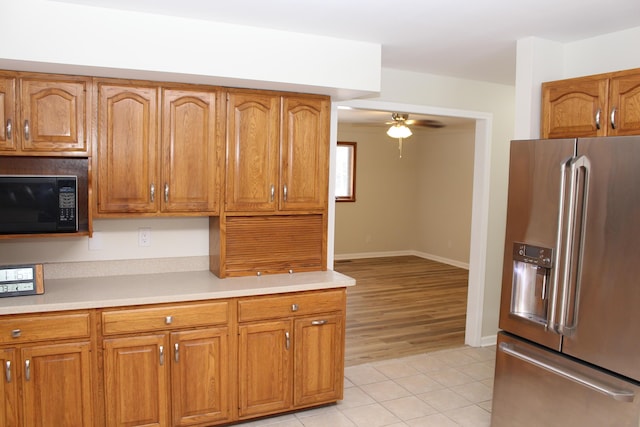 kitchen with light tile patterned flooring, ceiling fan, and high end refrigerator