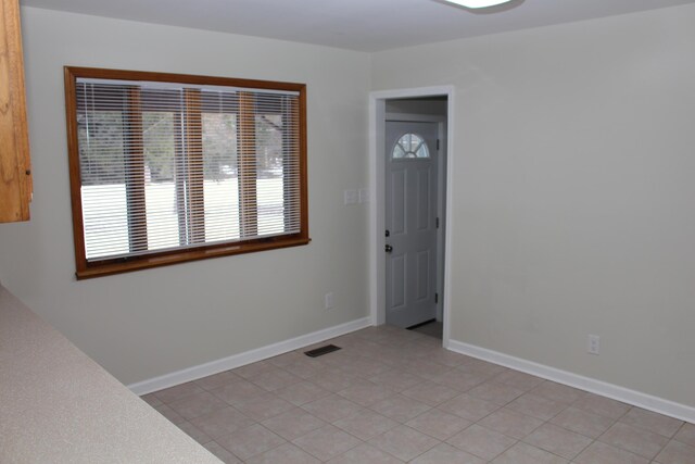 empty room with light tile patterned floors