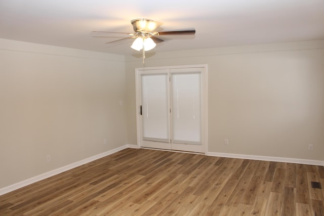 spare room with ceiling fan and wood-type flooring