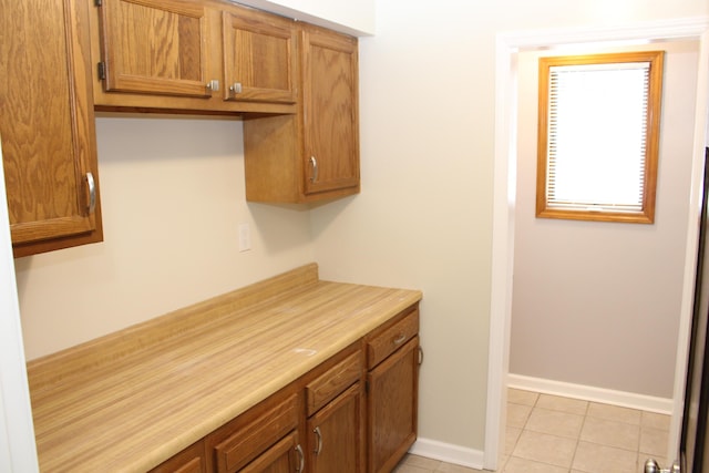 kitchen with light tile patterned flooring