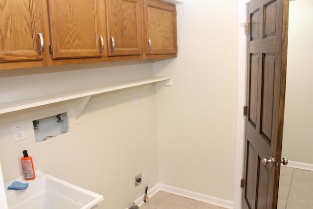 clothes washing area featuring light tile patterned flooring, cabinets, hookup for a washing machine, and electric dryer hookup