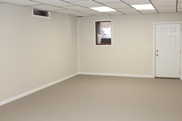 basement featuring a paneled ceiling