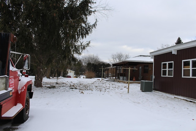 yard covered in snow with central air condition unit