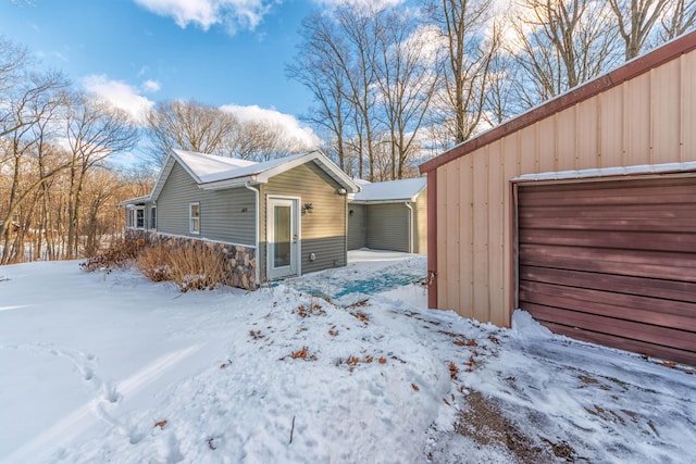 snow covered property featuring a garage