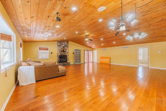 unfurnished living room featuring a fireplace, lofted ceiling, ceiling fan, light hardwood / wood-style floors, and wooden ceiling