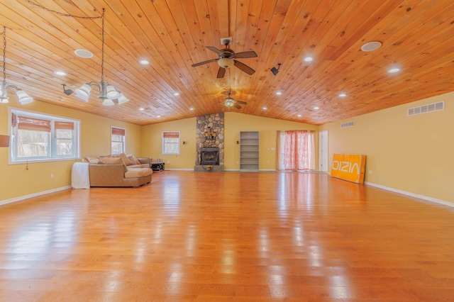 unfurnished living room featuring lofted ceiling, wood ceiling, ceiling fan, light hardwood / wood-style floors, and a stone fireplace