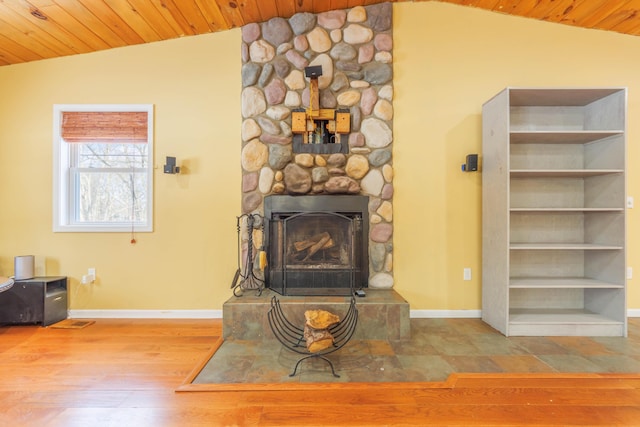 living room with lofted ceiling, a fireplace, and hardwood / wood-style floors