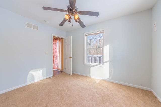 unfurnished room with ceiling fan and light carpet