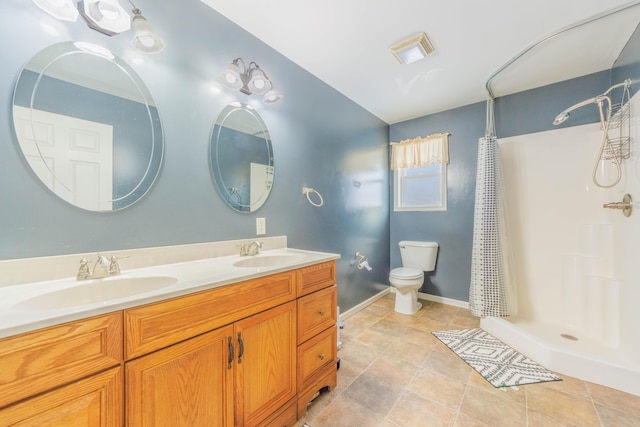 bathroom featuring walk in shower, vanity, and toilet