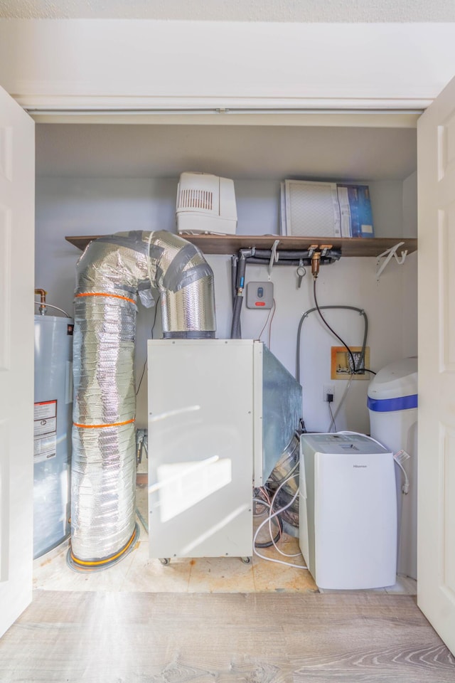 utility room featuring water heater