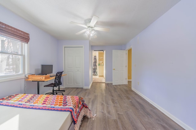 bedroom with ceiling fan and light wood-type flooring