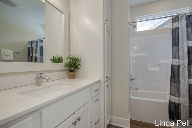 bathroom with visible vents, vanity, and shower / bath combination with curtain