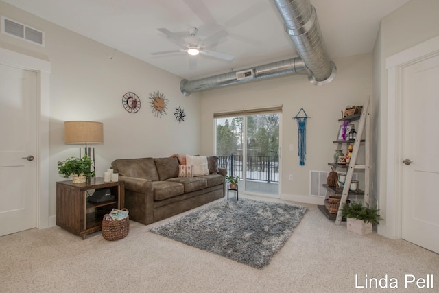 carpeted living room with visible vents and a ceiling fan