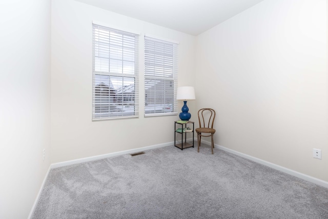 spare room featuring light colored carpet