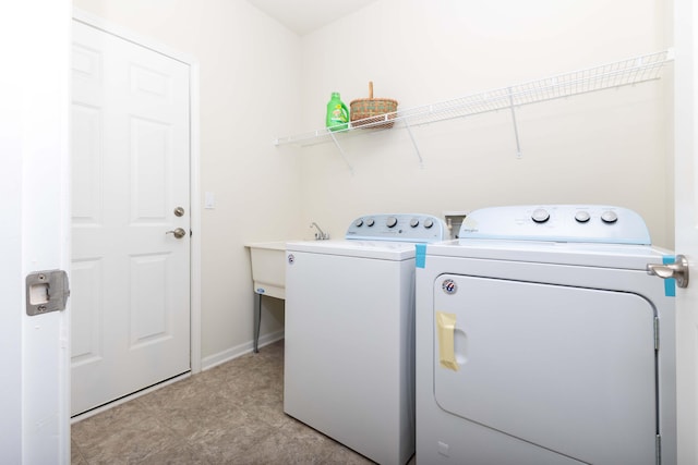 laundry area with independent washer and dryer and sink