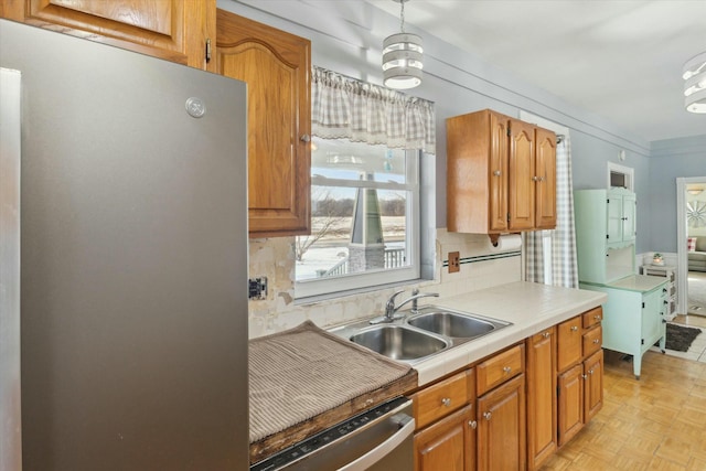 kitchen featuring sink, decorative backsplash, light parquet floors, and appliances with stainless steel finishes